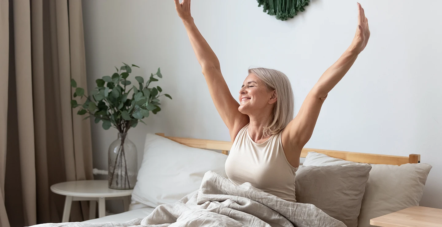 Woman waking up from a restful night sleep after taking melatonin 