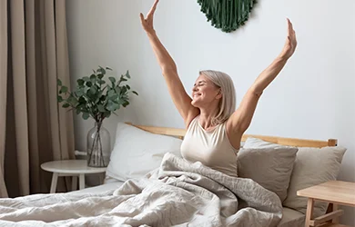 Woman waking up from a restful night sleep after taking melatonin 